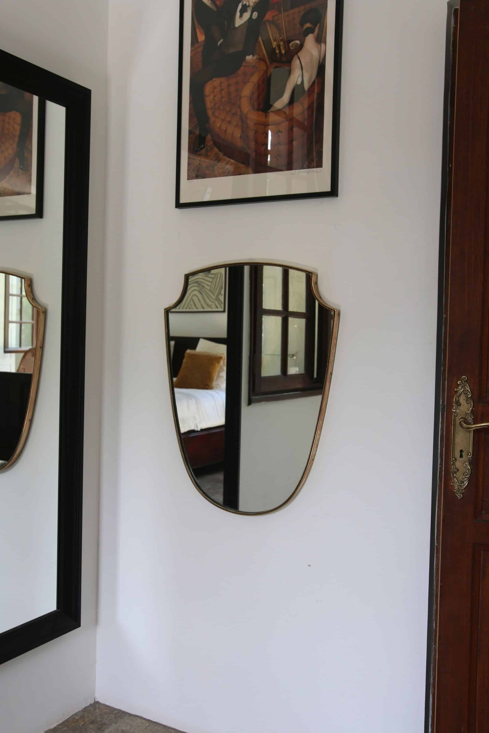 Brass mirror with crest, bead frieze, Italian design style.