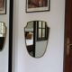 Brass mirror with crest, bead frieze, Italian design style.
