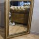 Old Louis Philippe style mirror in gilded wood with pediment
