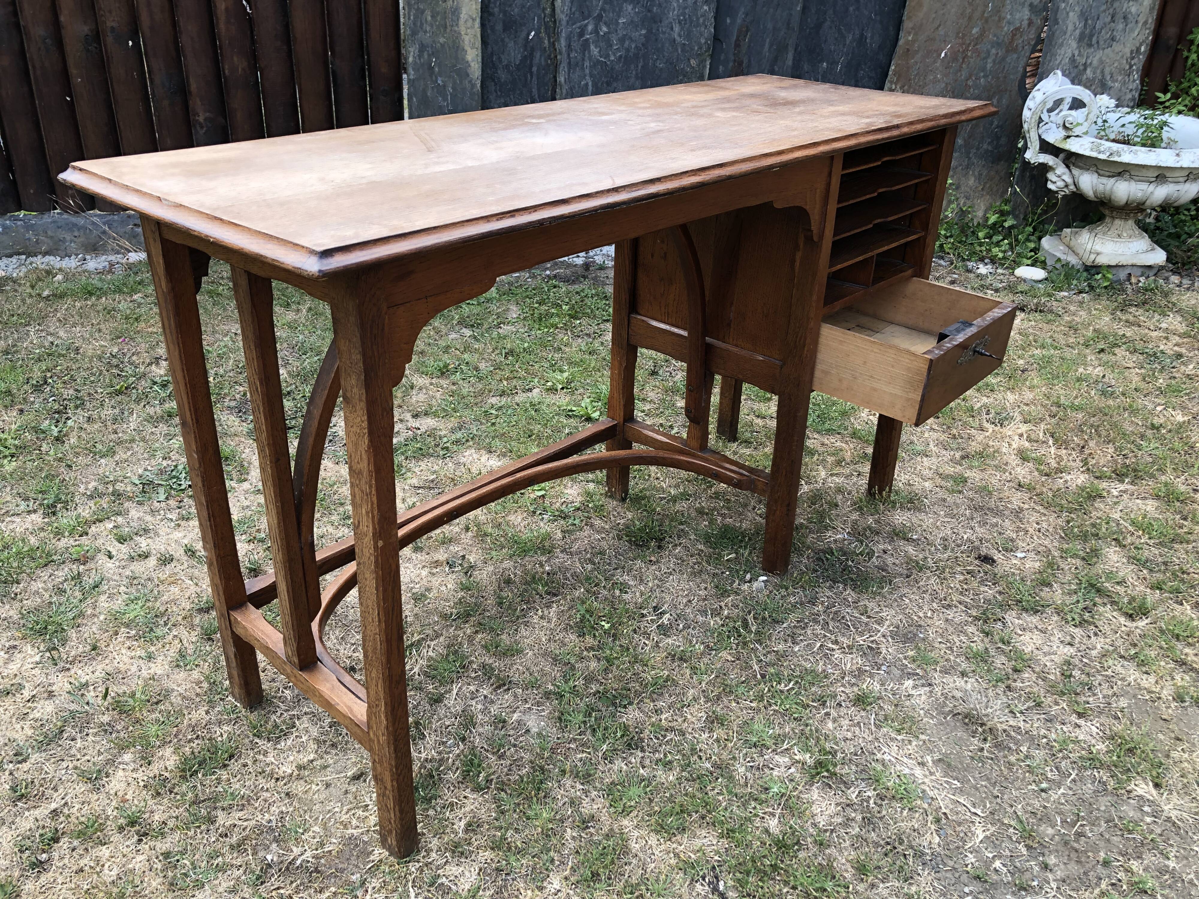 Old oak desk with curved wooden sleepers in the Art Nouveau spirit of the early 20th century.
