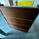 Vintage 1960s wooden library with sliding doors.
