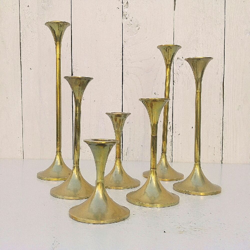 Seven candle holders in golden brass vintage trend
