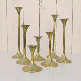 Seven candle holders in golden brass vintage trend