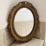 Old oval mirror in gilded resin