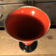 Cut vase on foot in red and black metal