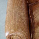 Graceful, stylish, timeless and comfortable wing chair made of cowhide in English style