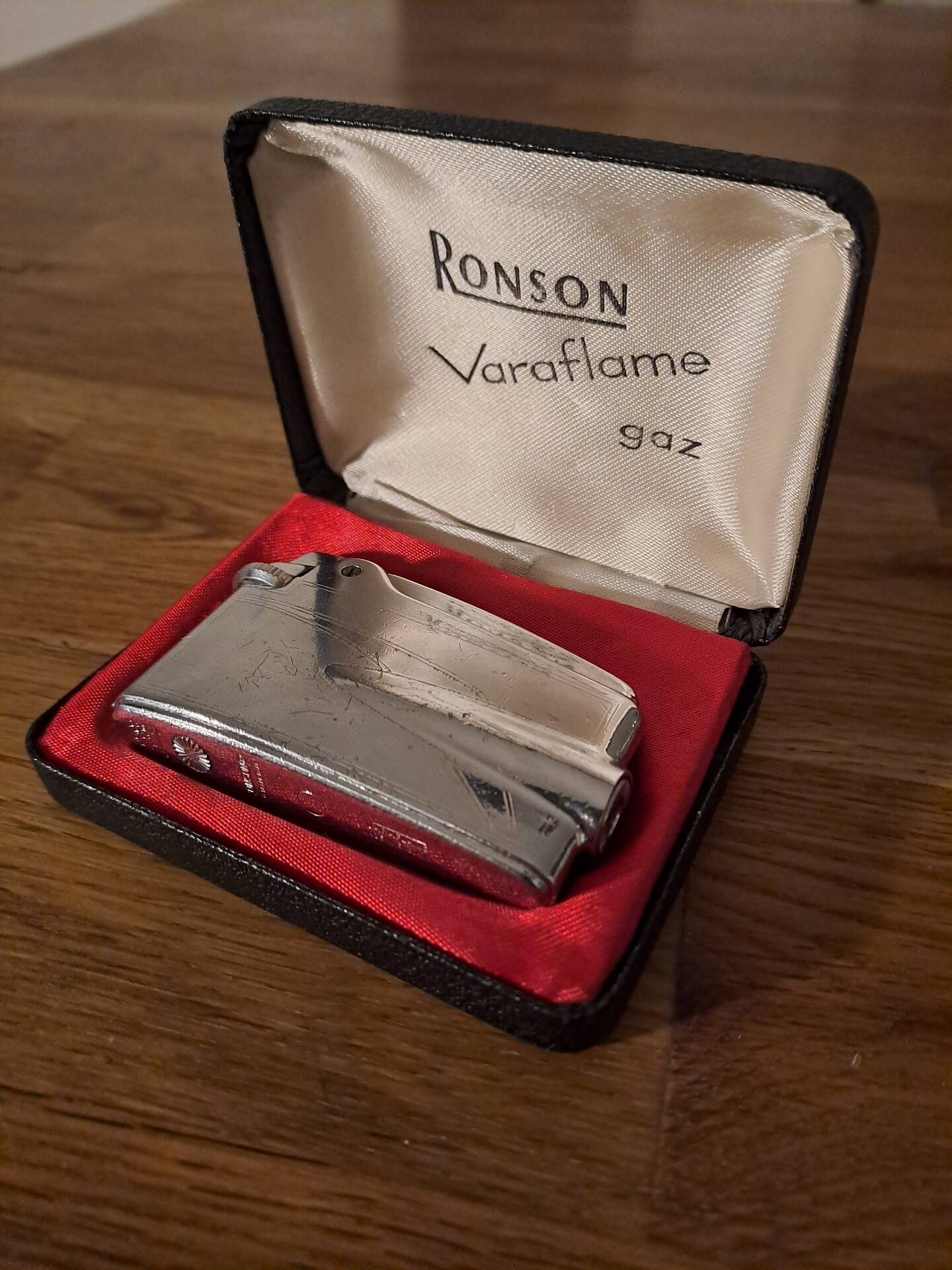 Vintage Ronson Varaflame chrome lighter and its original case.