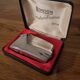 Vintage Ronson Varaflame chrome lighter and its original case.