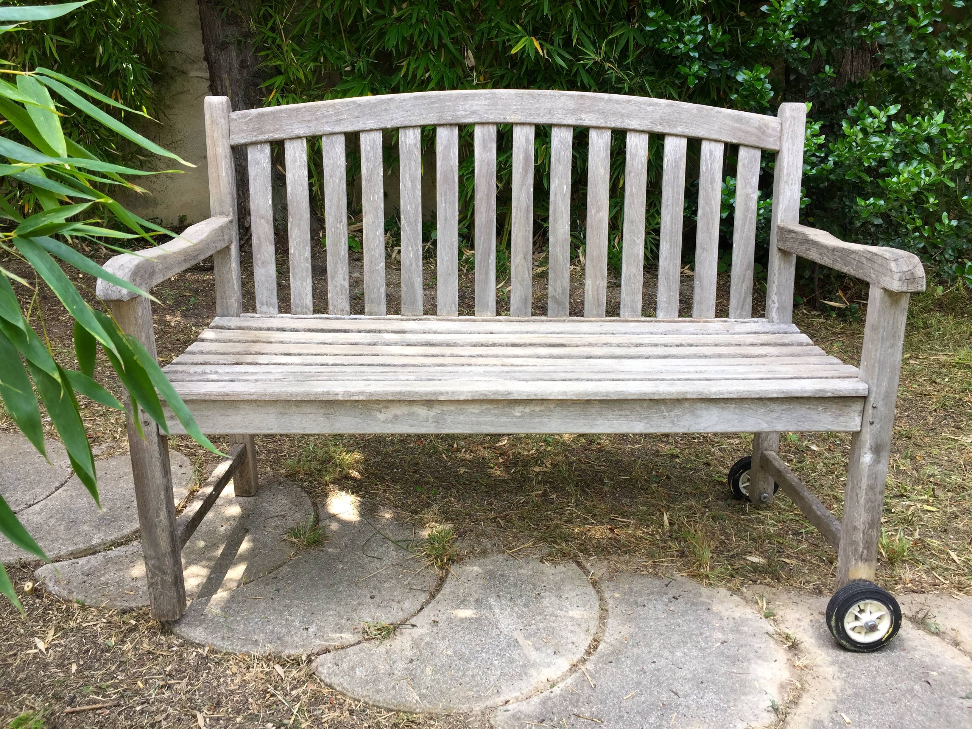 Vintage wooden garden bench with wheels