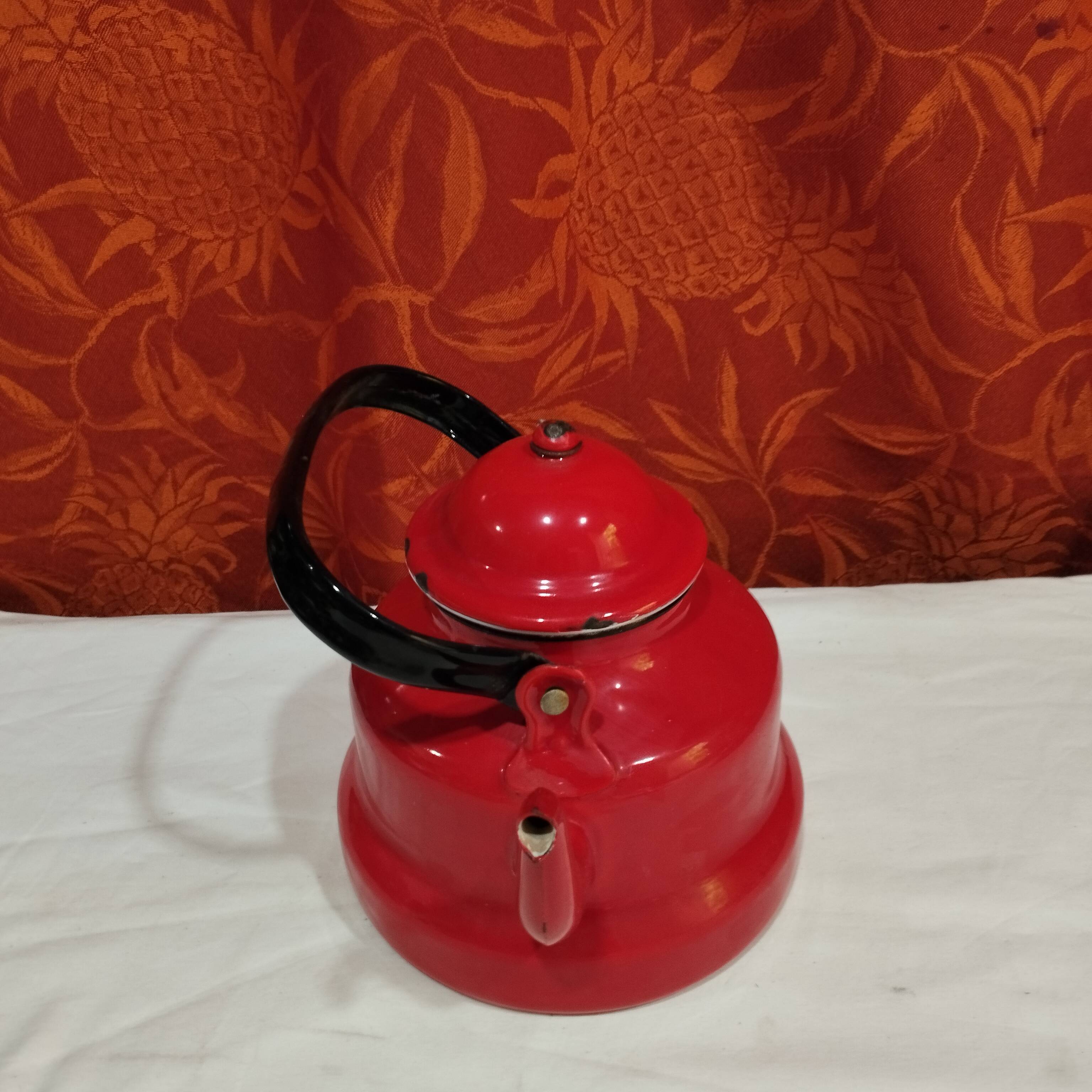 red enamelled sheet metal kettle