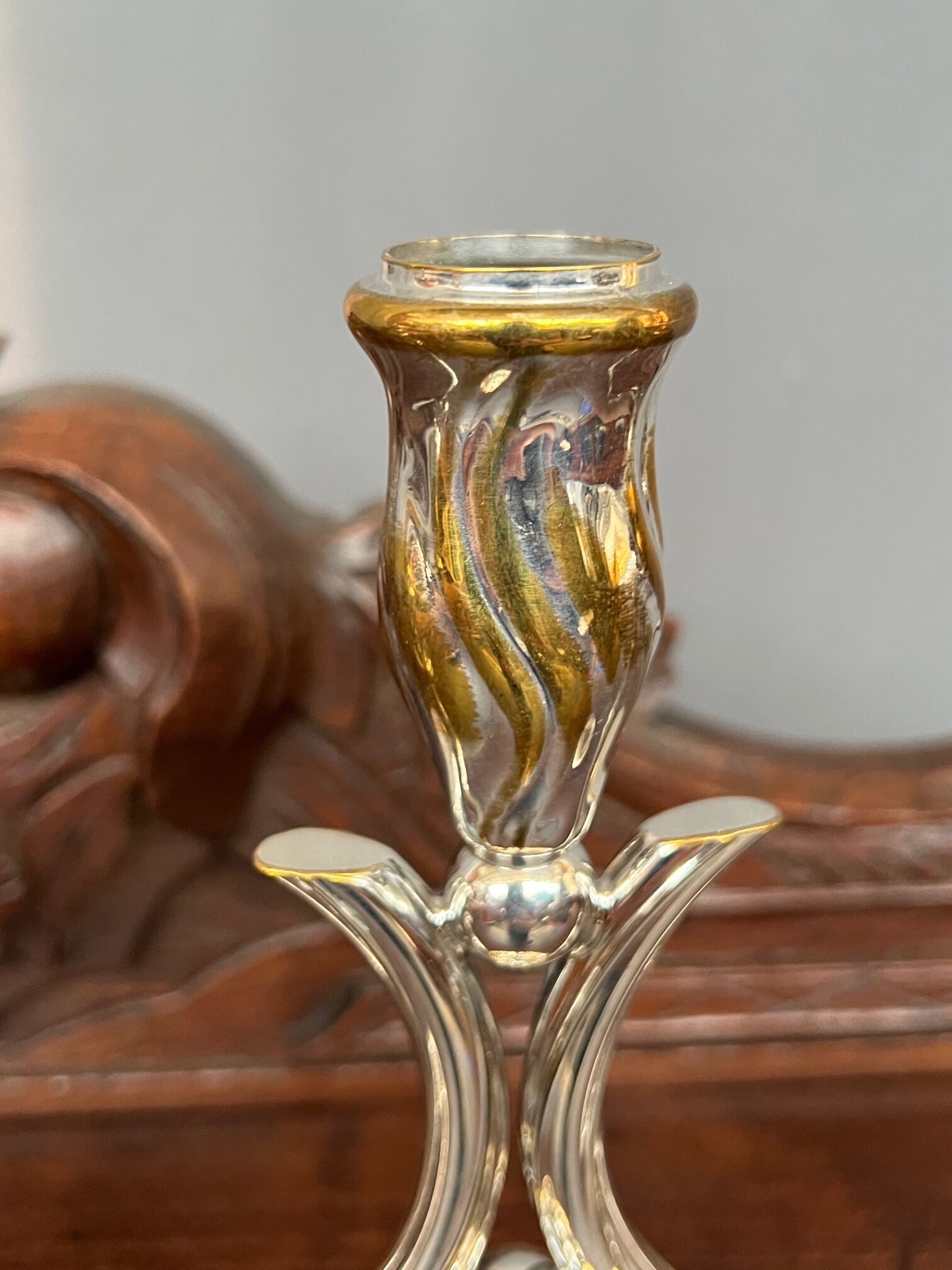 A pair of candlesticks. silver metal with gold decoration.