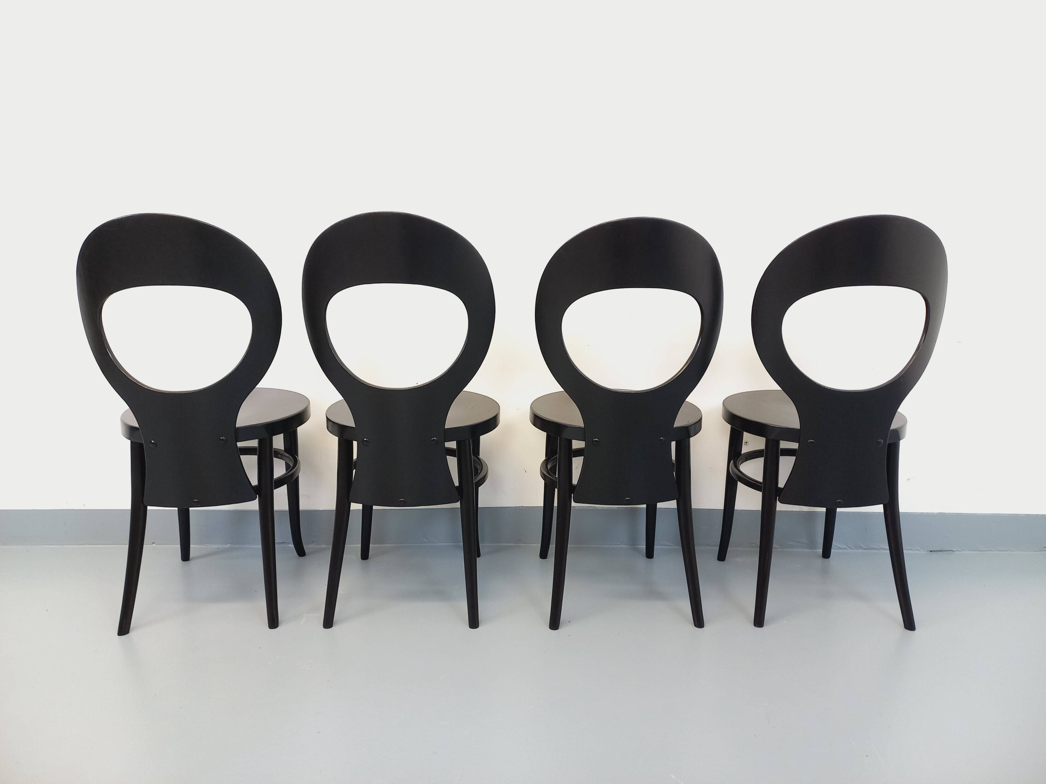 Set of 4 vintage Mouette chairs by Baumann in black wood from the 1960s.