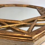 Octagonal mirror in gilded wood with closed guards
