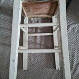 Vintage wooden stool with white peeling paint