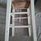 Vintage wooden stool with white peeling paint