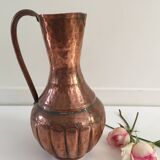 Pitcher-shaped vase in hammered copper