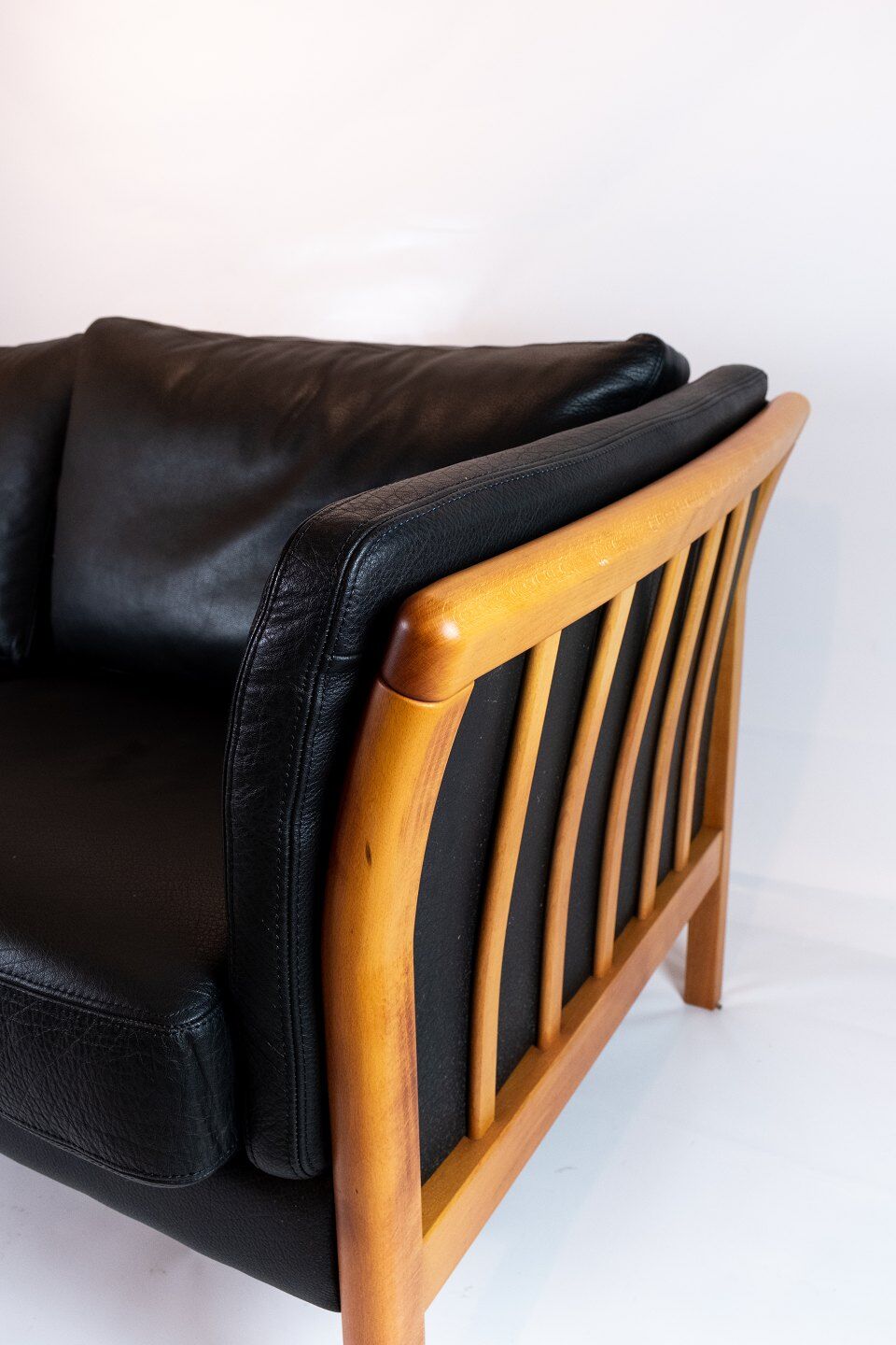 Two seater sofa upholstered with black leather and of danish design