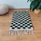 Small Berber rug with green tiles.