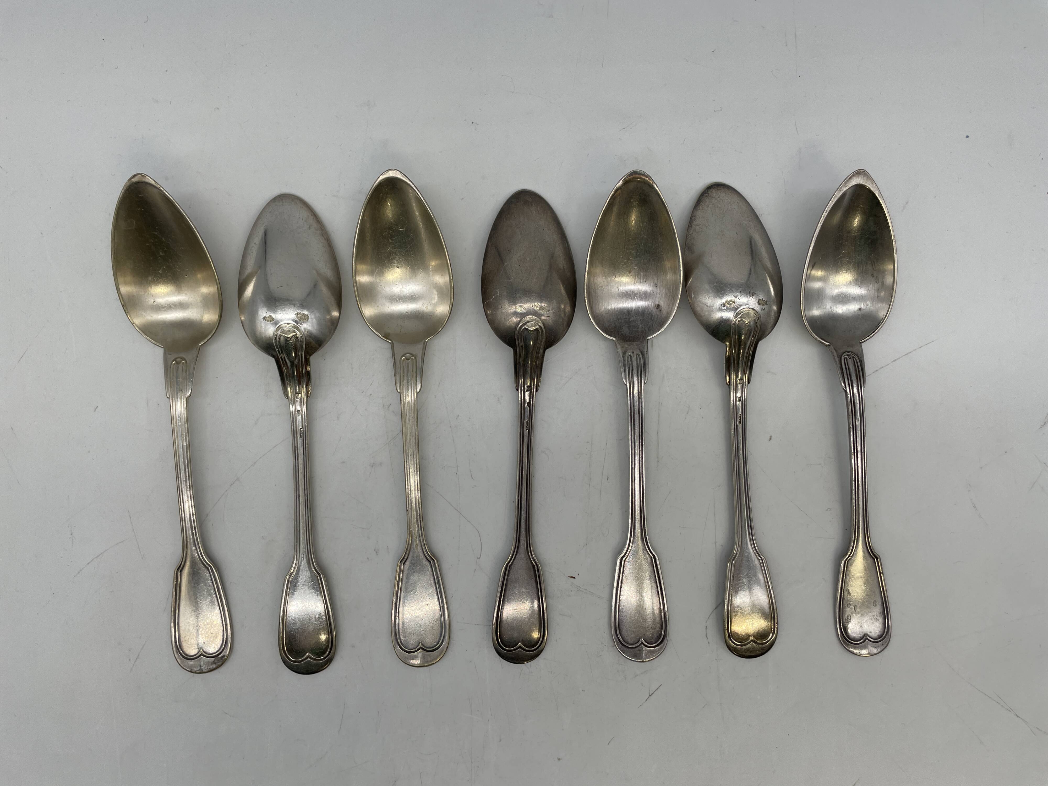 Set of 7 silver-plated dessert spoons with a bi-lobed filet pattern.
