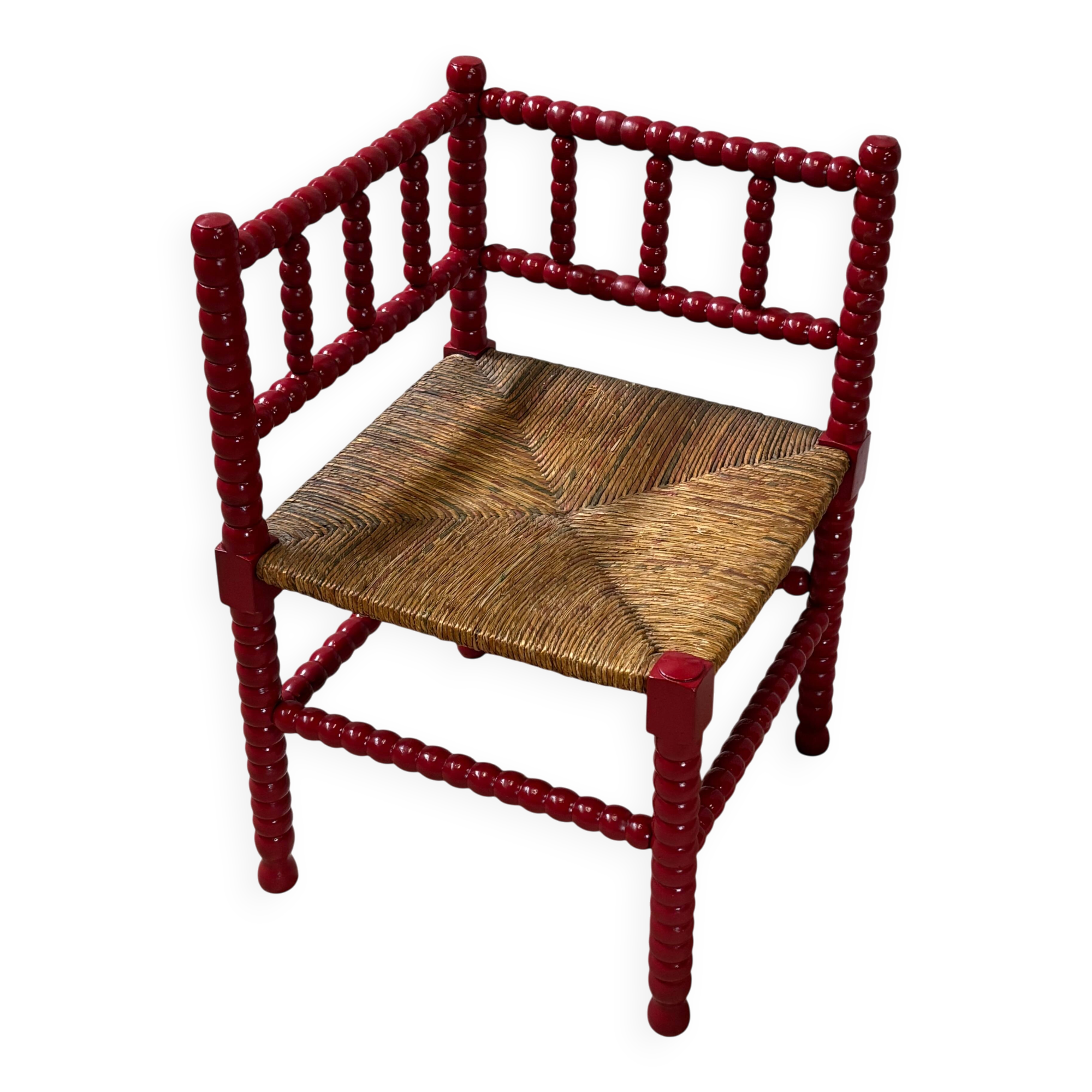 Red turned wood corner chair with rush seating