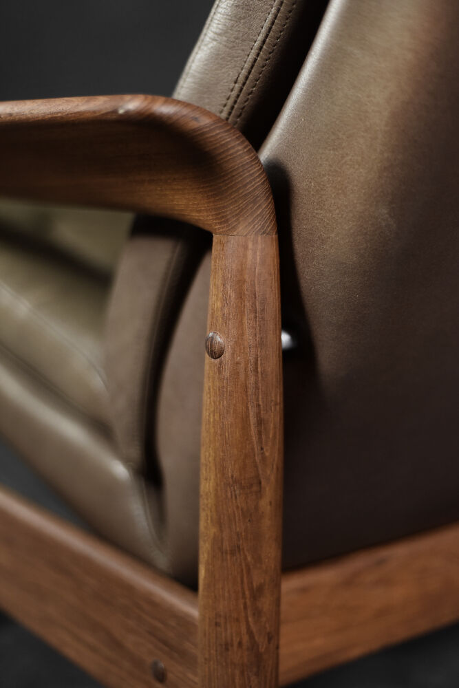 High teak and brown leather armchair with reclining backrest, mid-century Danish style, 1960s.