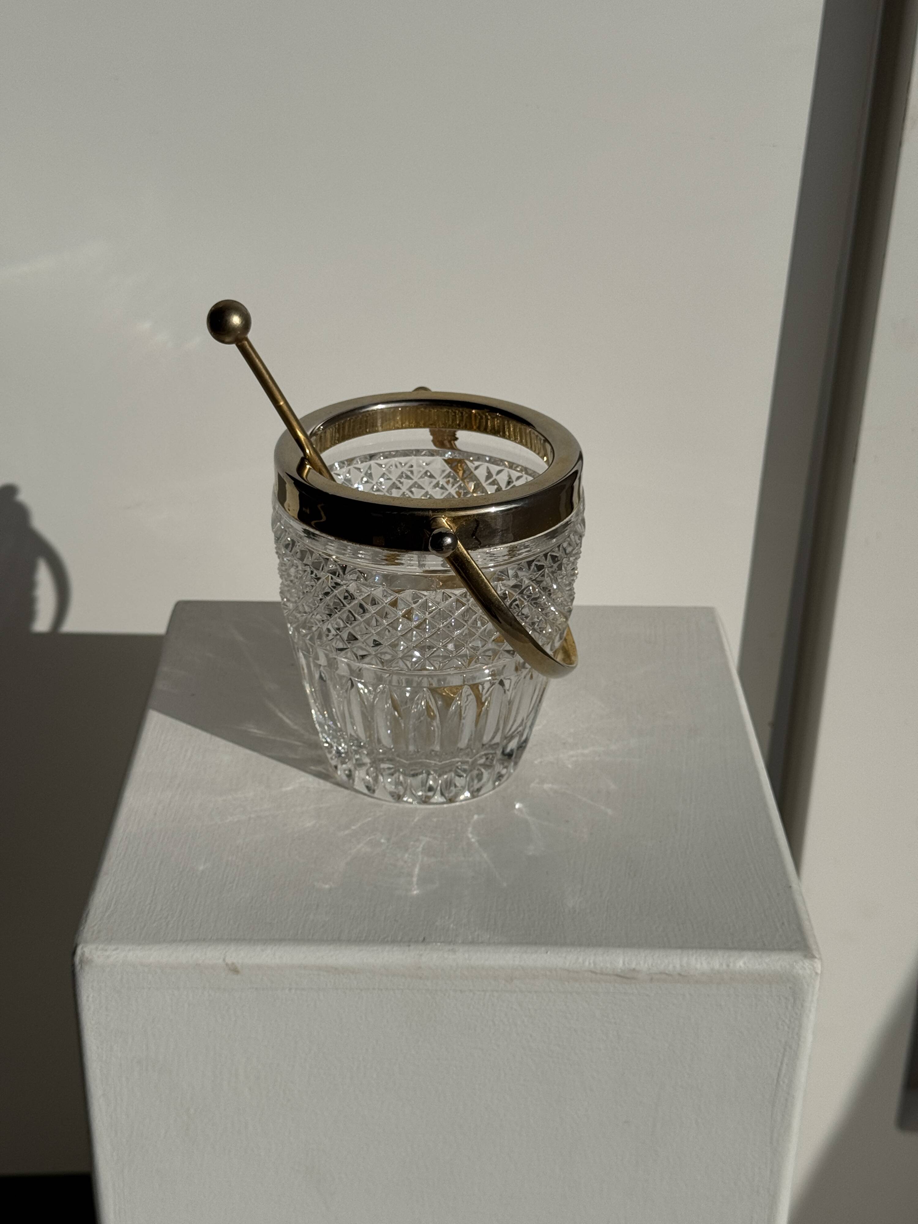 Small golden glass ice bucket with diamond point design and its scoop.