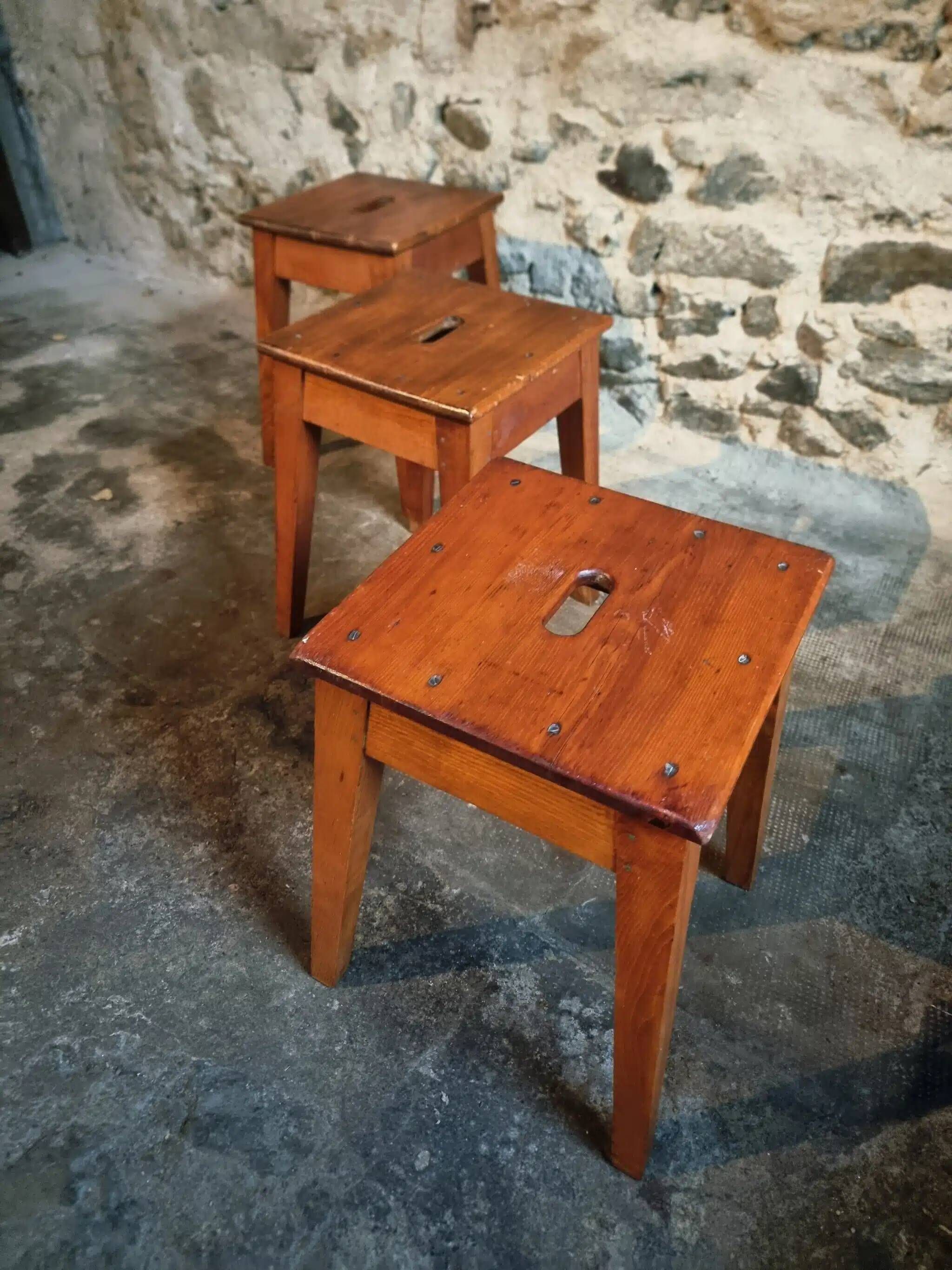 Set of 3 vintage French wooden stools from the 1950s.