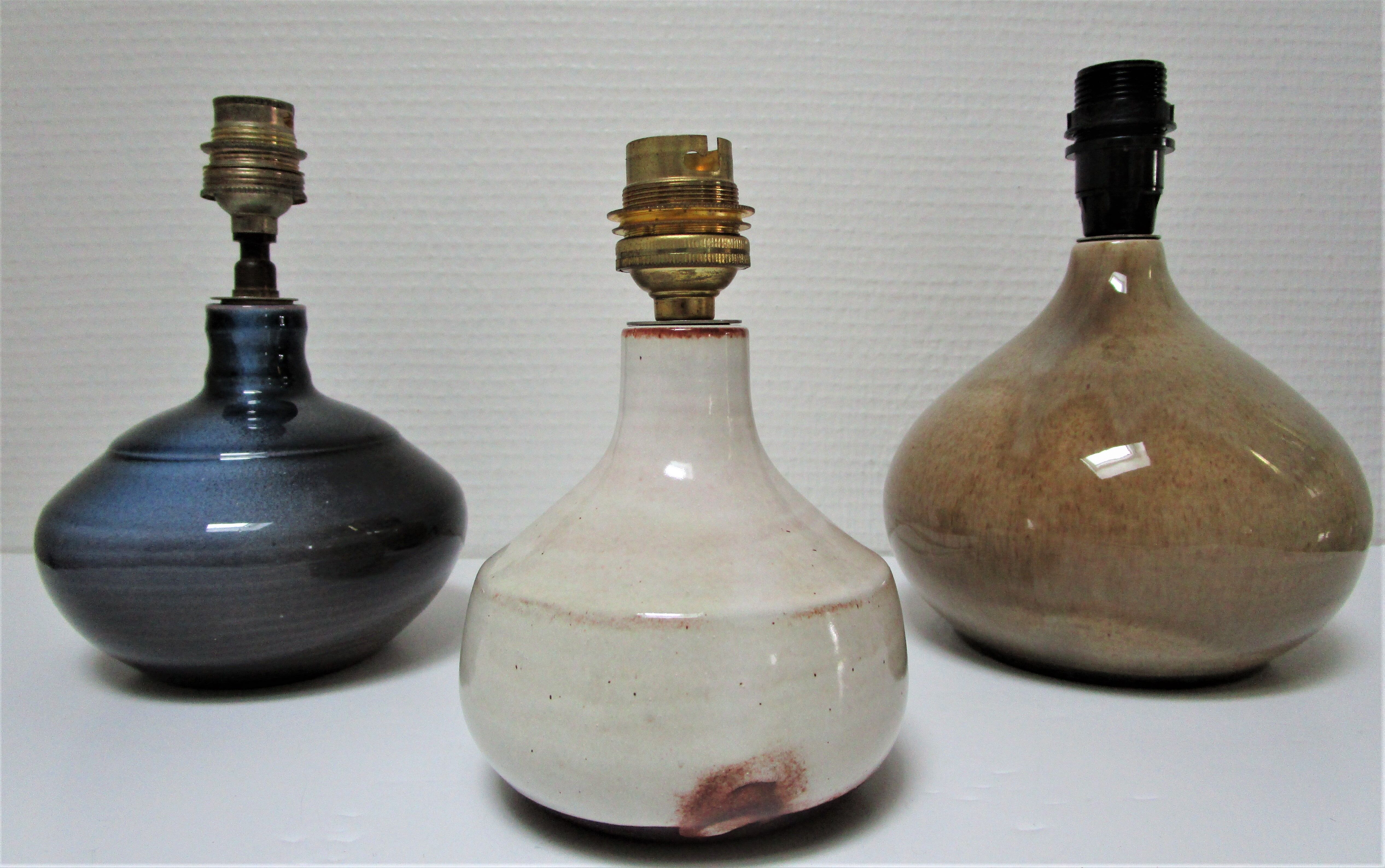 Three vintage ceramic lamps in blue, white and suede