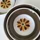 Set of three Italian deep plates from the 1970s, with ochre brown floral decoration.