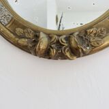 Oval wall mirror, golden floral pattern in stucco and wood, late 19th century