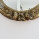 Oval wall mirror, golden floral pattern in stucco and wood, late 19th century