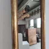 Long wooden mirror and gilded stucco with pearl rays H: 2m45 L: 40cm