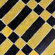 Round coffee table in yellow and black zellige, Moroccan graphic pattern.
