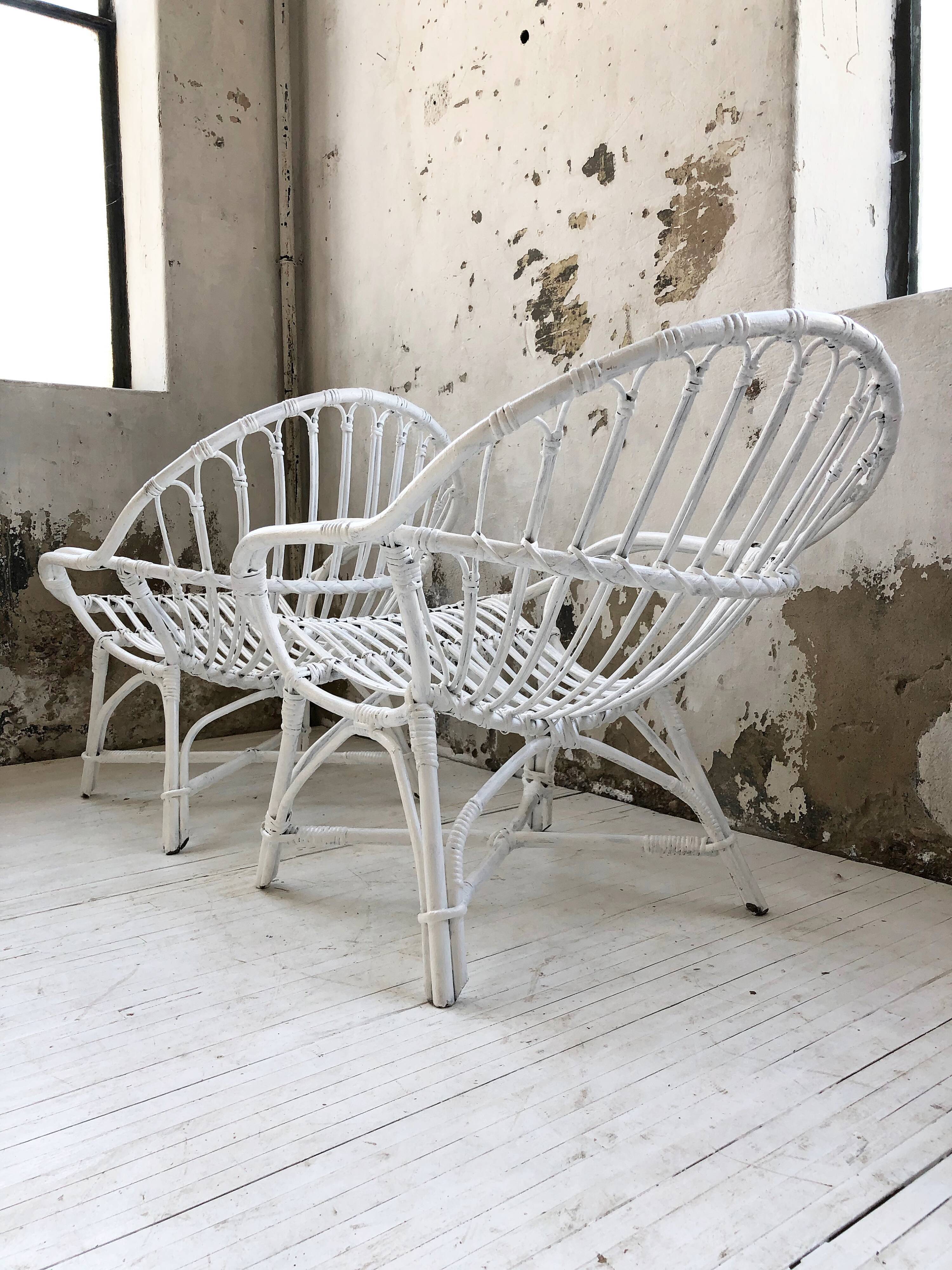 Pair of white rotin armchairs