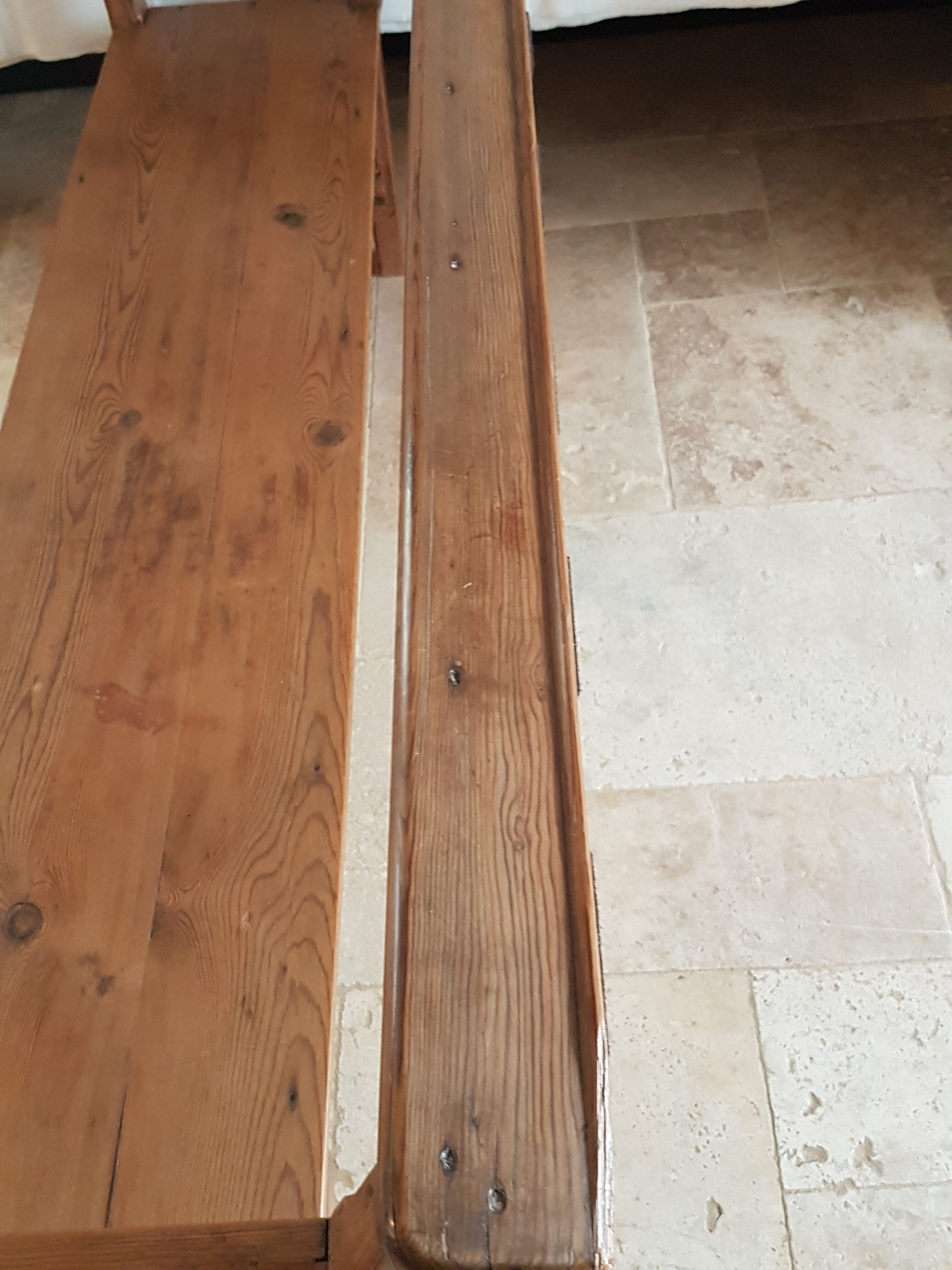 Church bench in fir tree with armrests
