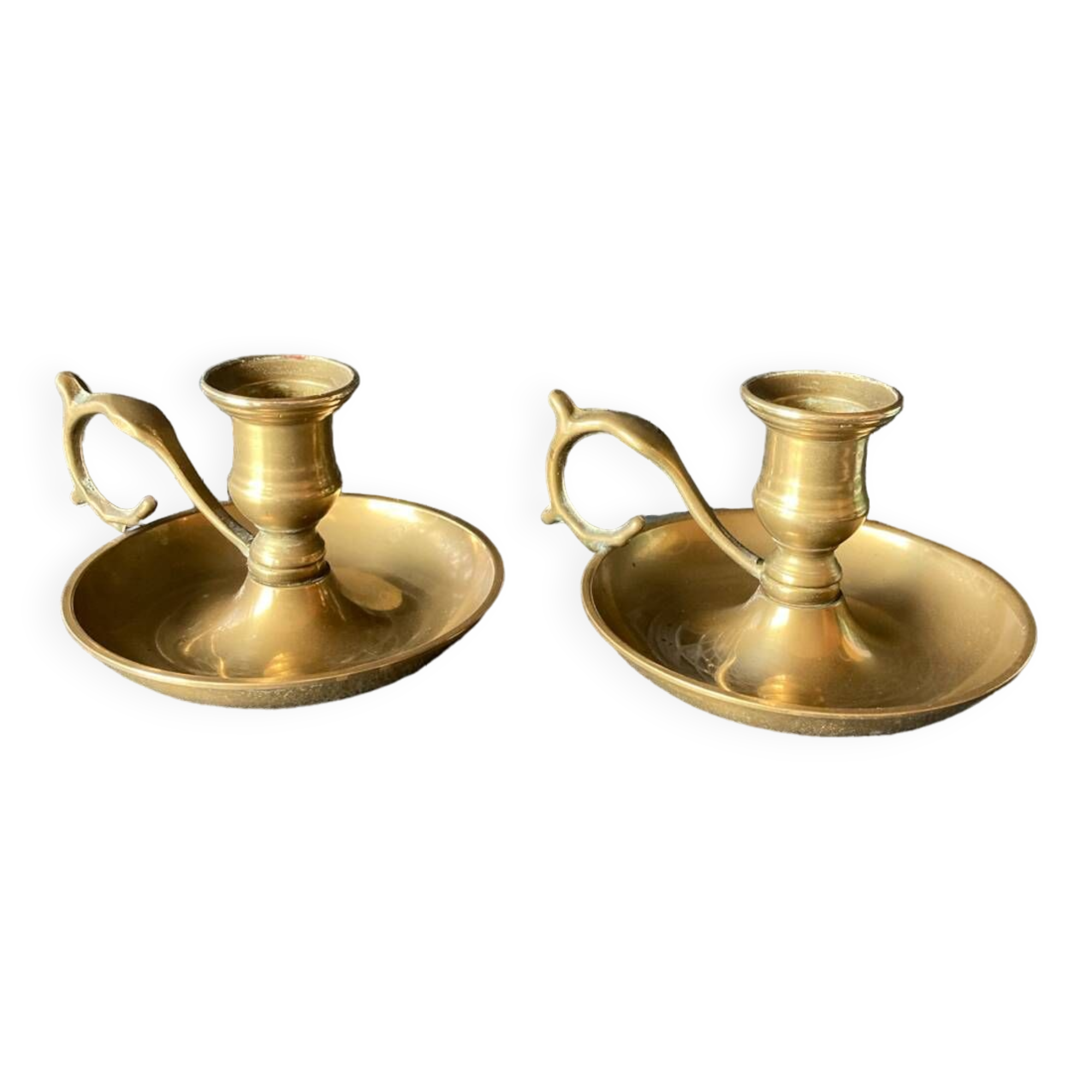 Two brass hand candle holders