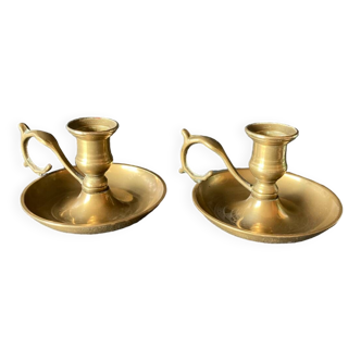 Two brass hand candle holders