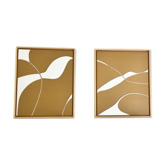 Diptych relief panels with a brown camel and cream background.