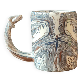 Handcrafted ceramic mug with marbled design, unique piece.