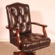 Office chair known as a director's chair in wood and tufted leather.
