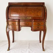 Louis XV cylinder desk with floral marquetry and gilded ornaments.