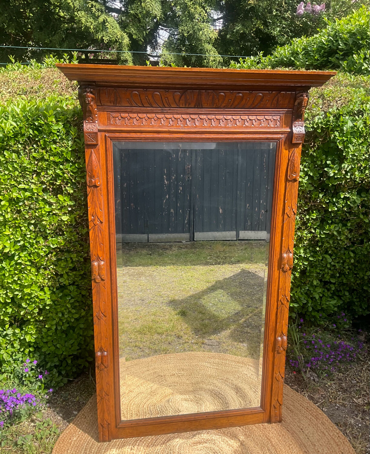 Antique large trumeau mirror in solid wood and bevelled glass.
