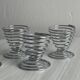 Set of 4 designer egg cups in shiny silver metal