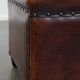 Cognac-colored sheepskin stool with decorative studs