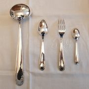 Silver cutlery set for 36 place settings and its ladle.
