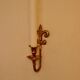 A pair of antique brass wall sconces.