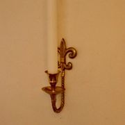 A pair of antique brass wall sconces.