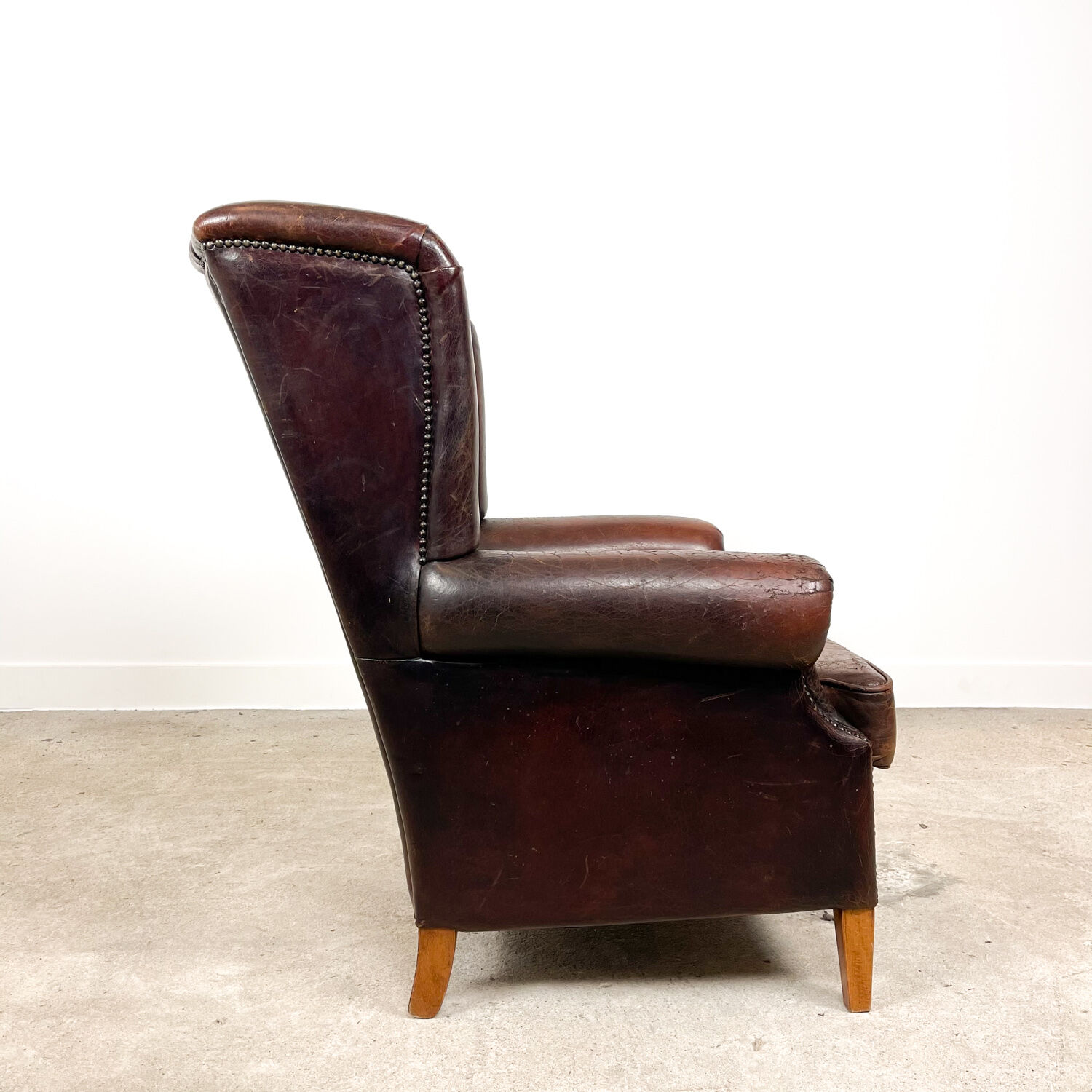 Dark brown vintage sheep leather wingback armchair