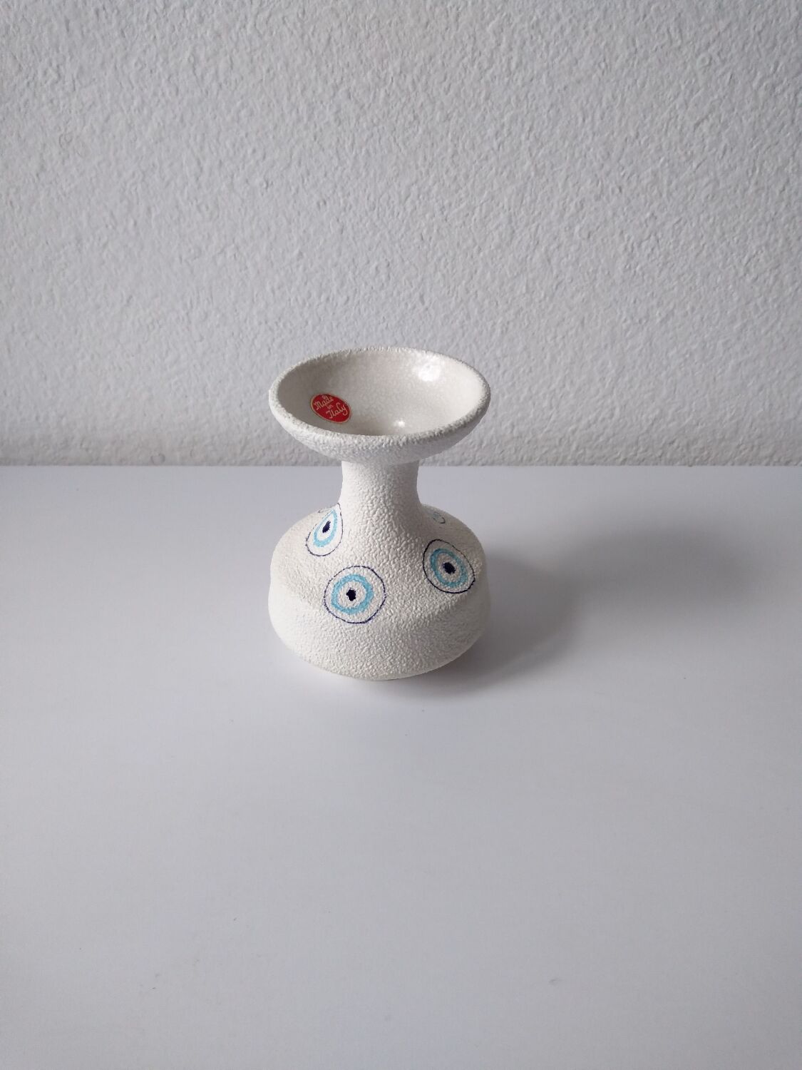 White and blue ceramic vase with italian relief