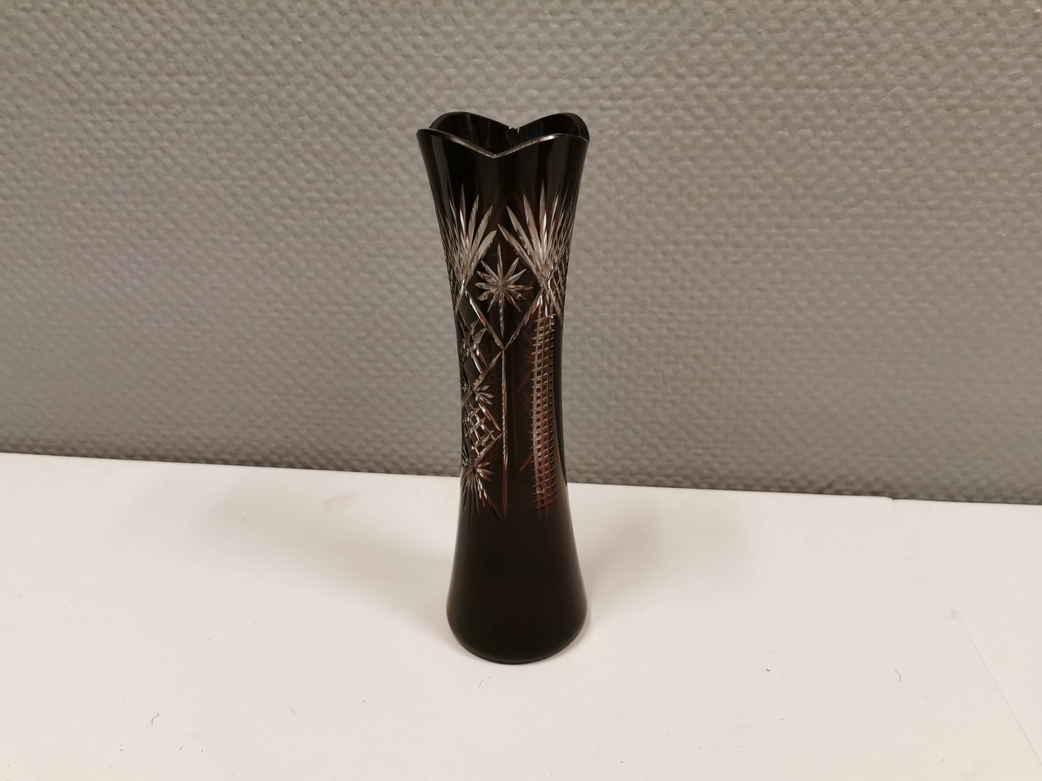 Crystal glass vase, in burgundy/reddish coloured glass with translucent details.